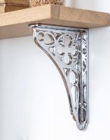 The 18 x 13cm Bright Chrome Coalbrookdale Shelf Bracket Mounted on a White Modern Home Interior Wall - Digital Illustration 