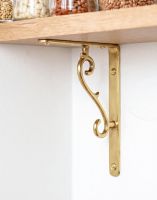 The 18 x 14cm Brass Scroll Effect Bracket on a Cream Coloured Interior Wall - Digital Illustration 