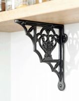 The 19 x 16cm "Blossville" Iron Shelf Bracket Mounted on a Wooden Shelf Attached to a Modern White Interior Wall - Digital Illustration 