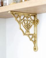 The 19cm x 16cm "Blossville" Brass Wall Bracket Used as a Wall Hanger on a Wooden Shelf - Digital Illustration 