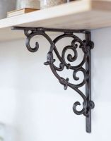 The 20 x 23cm Cast Iron Tulip Design Shelf Bracket Mounted on a Cream Coloured Living Room Wall - Digital Illustration