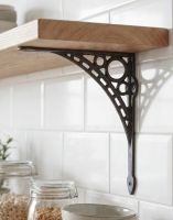 The 20cm x 22cm "Iron Bridge" Cast Iron Shelf Bracket Mounted on a Contemporary Interior Tiled Wall on a DIY Wooden Shelf - Digital Illustration