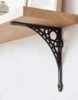 The 20cm x 22cm Midnight Black "Iron Bridge" Shelf Bracket Mounted on a White Wall as part of a DIY Wooden Shelf - Digital Illustration