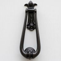 The "Addison Loop" Door Knocker in a Black Finish Shown on a White Door close up - Digital Illustration The "Addison Loop" Door Knocker in a Black Finish Shown on a White Door close up - Digital Illustration