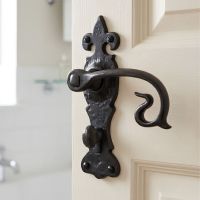 The "Alvito" Black Curly Lever Bathroom Set on a Cream Coloured Door with an Integrated Thumbturn Lock - Digital Illustration