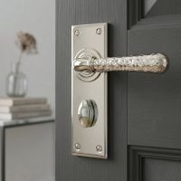The "Amsden House" Hammered Polished Nickel Lever Bathroom Door Handle on an Ensuite Door with Thumbturn Lock - Digital Illustration 
