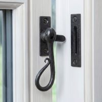 The "Appley Keep" Shepherd"s Crook Reversible Window Fastener in a Beeswax Finish Fitted on a White Window Frame in a Country Home - Digital Illustration The "Appley Keep" Shepherd"s Crook Reversible Window Fastener in a Beeswax Finish Fitted on a White Window Frame in a Country Home - Digital Illustration