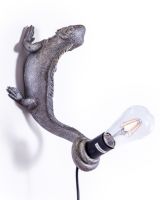 The "Arboreal Guardian" Iguana Wall Light in Silver Shown Mounted on a White Wall 