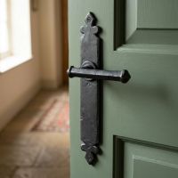The "Arundell" Beeswax Tudor Lever Latch Set on a Green Door in a Hall of a Home - Digital Illustration 