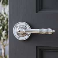 The "Balcroft" Polished Nickle Beehive Lever Handles on a Dark Grey Door in a Cosy Modern Home - Digital Illustration