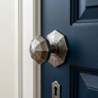 The "Beaufort" Pewter Patina Octagonal Centre Door Knob Fitted on a Blue Door in a Modern Home - Digital Illustration