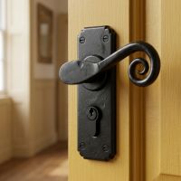 The "Birchwood" Black Monkeytail Euro Lock Lever Door Handle on a Yellow Hallway Door in a Country Home - Digital Illustration
