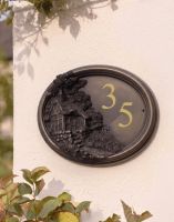 The "Blakeney Croft" Thatched Cottage House Number Sign on a House Front Above a Hedge - Digital Illustration The "Blakeney Croft" Thatched Cottage House Number Sign on a House Front Above a Hedge - Digital Illustration