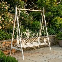 The "Blenheim" Ornate Arched Garden Swing Seat on a Sunny Garden Patio in a Cream Finish - Digital Illustration The "Blenheim" Ornate Arched Garden Swing Seat on a Sunny Garden Patio in a Cream Finish - Digital Illustration