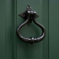The "Capulet" Shakespeare Door Knocker Mounted on a Green Door on a Period Property - Digital Illustration The "Capulet" Shakespeare Door Knocker Mounted on a Green Door on a Period Property - Digital Illustration