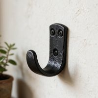 The "Dareshill" Iron Coat Hook Fitted onto a White Wall in a Modern Home - Digital Illustration