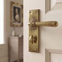 The "Emerson" Antique Brass Sprung Lever Door Handles With Bathroom Lock on the Door of an Ensuite - Digital Illustration