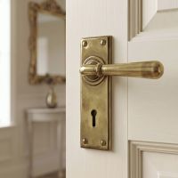 The "Emerson" Antique Brass Sprung Lever Handles with Keyhole on a Cream Coloured Door in a Country Home - Digital Illustration
