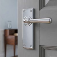 The "Emerson" Bright Chrome Traditional Lever Door Handles on a Light Grey Coloured Door in a Modern Home - Digital Illustration