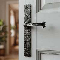 The "Farrington" Long Profile Cast Iron Lever Handle With Key Hole on a Light Grey Door in a Sunny Home - Digital Illustration