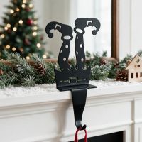 The "Frosty McJingles" Elf Stocking Holder Displayed on a White Mantelpiece in a Modern Home - Digital Illustration The "Frosty McJingles" Elf Stocking Holder Displayed on a White Mantelpiece in a Modern Home - Digital Illustration