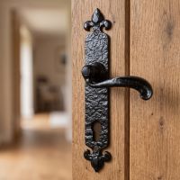 The "Galloway" Long Profile Fleur de Lys Door Handles With Keyhole and Euro Lock Hole on a Wooden Door in a Period Home - Digital Illustration