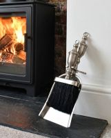 The "Grecian" Pewter Brush and Pan Set by a White Fireplace with a Lit Log Burner Stove - Digital Illustration 