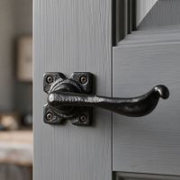 The "Hulmrood" Iron Lever Handle on a Light Grey Door in a Modern Interior Setting - Digital Illustration