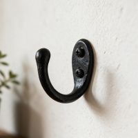 The "Hulmwick" Simple Iron Coat Hook on a White Wall in a Modern Home - Digital Illustration