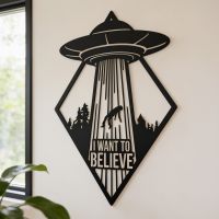 The "I Want to Believe" Black Alien Wall Art next to an Indoor House Plant and Window - Digital Illustration The "I Want to Believe" Black Alien Wall Art next to an Indoor House Plant and Window - Digital Illustration
