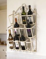 The "Jenevieve" Wall Mounted Wine Rack in a Cream Finish Mounted on a White Wall in a Modern Kitchen - Digital Illustration
