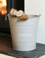 The "Kindling" Log Store Bucket holding some logs next to a Log Burner Stove - Digital Illustration 