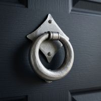 The "Lorien" Pewter Ring Door Knocker  Fitted onto a Navy Blue Front Door - Digital Illustration
