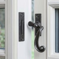 The "Melbridge" Scrolled Black Iron Window Fastener Displayed Fitted on an Open White Window Frame - Digital Illustration The "Melbridge" Scrolled Black Iron Window Fastener Displayed Fitted on an Open White Window Frame - Digital Illustration