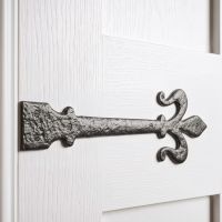 The "Middlemore" Fleur-De-Lys Cast Iron Hinge Shown Close up on a White Painted Timber Door - Digital Illustration 