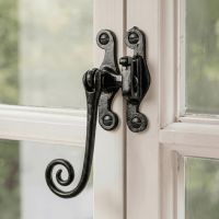 The "Padmoore" Iron Casement Stay Fitted on a Classic White Wooden Window Frame - Digital Illustration 