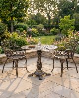 The "Penrose" 2-Seater Garden Dining Set - Brushed Gold digital illustration dressed table