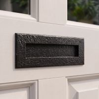 The "Reaseheath" Blacksmith Style Iron Letter Plate on a White Painted Wooden Entrance Door to a Home - Digital Illustration