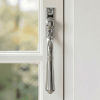 The "Regency" Polished Chrome Teardrop Espagnolette Window Fastener Fitted on a White Painted Window Frame - Digital Illustration