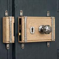 The "Sesille" Oak & Antique Pewter 5 Lever Rim Lock and Knob Set Mounted on an Entrance Door to a Traditional Home - Digital Illustration The "Sesille" Oak & Antique Pewter 5 Lever Rim Lock and Knob Set Mounted on an Entrance Door to a Traditional Home - Digital Illustration