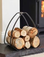 The "The Ternion" Contemporary Log Holder on a Black Stone Hearth next to Lit Log Burner - Digital Illustration The "The Ternion" Contemporary Log Holder on a Black Stone Hearth next to Lit Log Burner - Digital Illustration