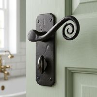 The "Ververt" Black Monkey tail Lever Bathroom Set on a Light Green Door Leading to a White Tiled Bathroom - Digital Illustration