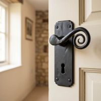 The "Ververt" Black Monkey Tail Lever Handle Set With Key Hole on a Cream Coloured Wooden Door in a Country Home - Digital Illustration .jpeg The "Ververt" Black Monkey Tail Lever Handle Set With Key Hole on a Cream Coloured Wooden Door in a Country Home - Digital Illustration .jpeg