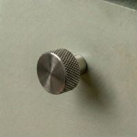 The "Vesper" Knurled Edge Cabinet Knob in Pewter for Kitchen Cupboards Mounted on a Sage Green Drawer - Digital Illustration The "Vesper" Knurled Edge Cabinet Knob in Pewter for Kitchen Cupboards Mounted on a Sage Green Drawer - Digital Illustration