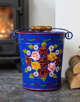 The 23cm Large Blue Narrowboat Hand Painted Bucket in a White Living Room next to a Log Burner Stove - Digital Illustration The 23cm Large Blue Narrowboat Hand Painted Bucket in a White Living Room next to a Log Burner Stove - Digital Illustration
