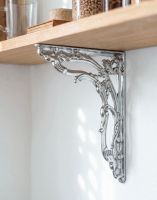 The 24 x 19cm "Victorian Amalina" Bright Chrome Ornate Scroll Bracket Fixed to a Wooden DIY Shelf on a White Interior Wall - Digital Illustration The 24 x 19cm "Victorian Amalina" Bright Chrome Ornate Scroll Bracket Fixed to a Wooden DIY Shelf on a White Interior Wall - Digital Illustration
