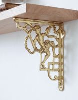 The 24 x 20cm Polished Brass Cherub Design Bracket Mounted on a a White Wall in a Modern Home - Digital Illustration The 24 x 20cm Polished Brass Cherub Design Bracket Mounted on a a White Wall in a Modern Home - Digital Illustration