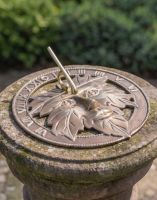 The 24cm Antique Brass "Greenman" Sundial Mounted on a Stone Pillar in a Sunny Garden - Digital Illustration The 24cm Antique Brass "Greenman" Sundial Mounted on a Stone Pillar in a Sunny Garden - Digital Illustration