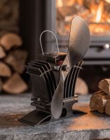 The 24cm Black "BelAir" Eco Wood Stove Fan Next to a Log Pile inside a Country Home Fireplace - Digital Illustration The 24cm Black "BelAir" Eco Wood Stove Fan Next to a Log Pile inside a Country Home Fireplace - Digital Illustration