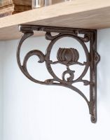 The 25 x 23cm "Lotus Flower" Iron Shelf Bracket Mounted on a White Kitchen Wall in a Contemporary Home - Digital Illustration 